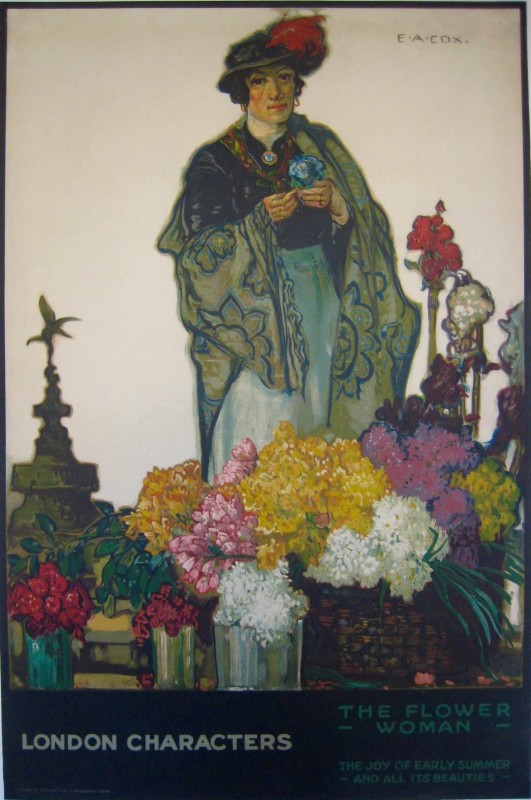 a woman holding a blue flower standing among containers of flowers