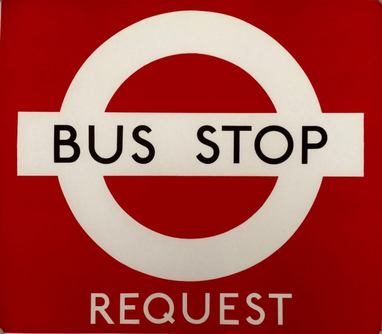 Bus Stop paper sign; London Transport logo, circle with cross bar saying bus stop. Red background