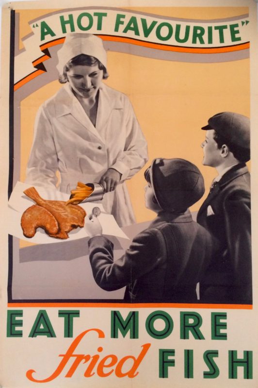 A cafeteria worker serving fried fish to children