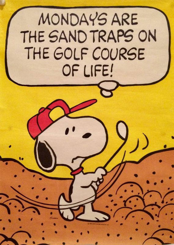 Snoopy paying golf, in a bunker