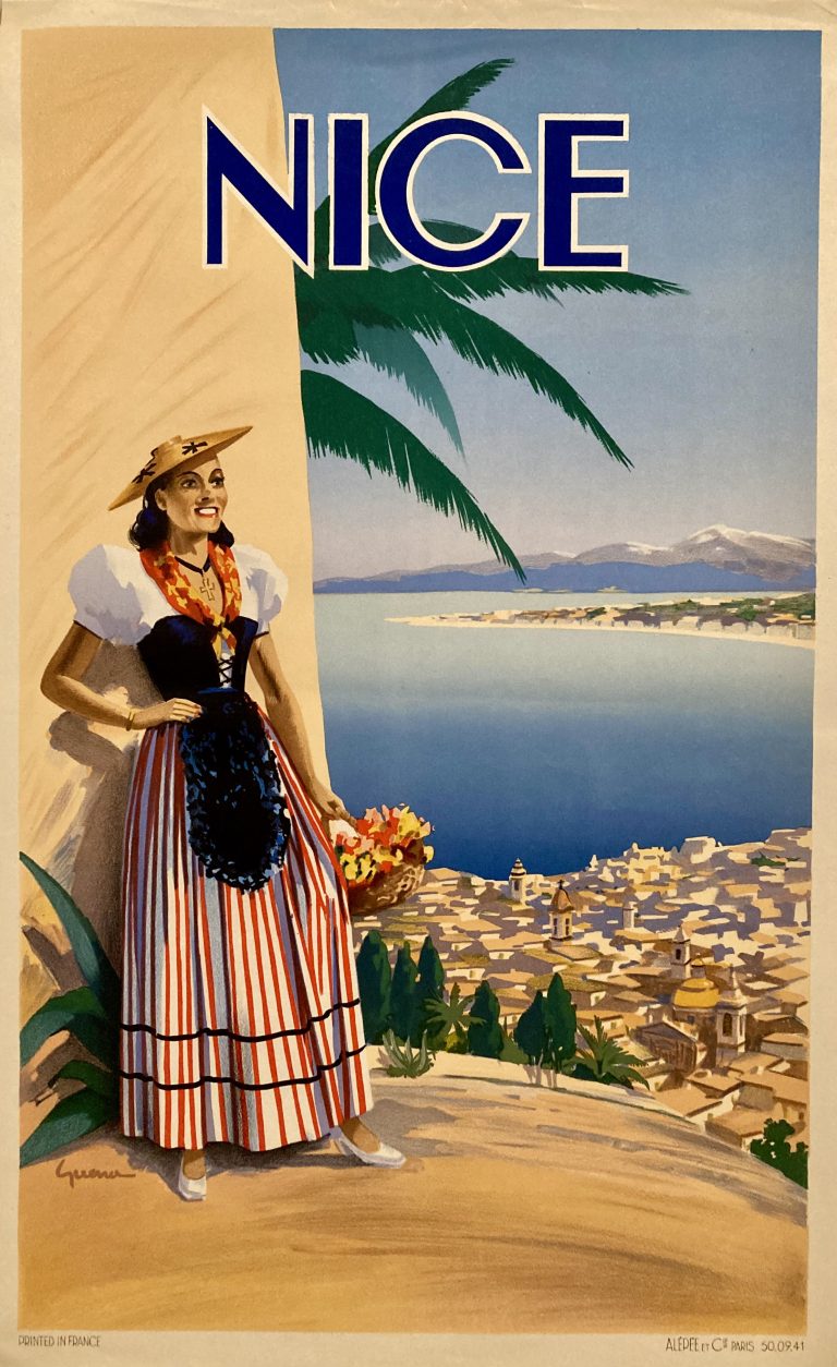 Woman in local dress stands in front of bay of Nice sea view